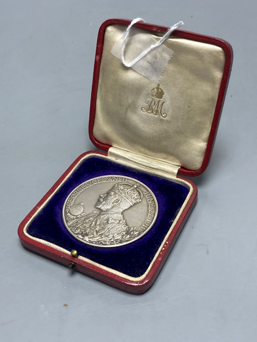 A cased George V silver coronation medal, 1911, by B. Mackennal, 51mm, 85g, GVF